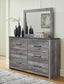 Bronyan King Panel Bed with Mirrored Dresser, Chest and Nightstand